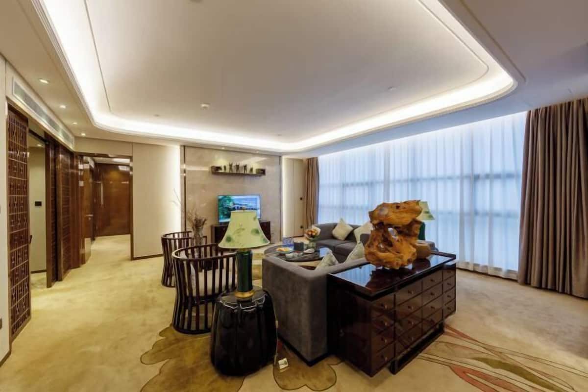 A modern living room with a sofa, coffee table, and decorative items.
