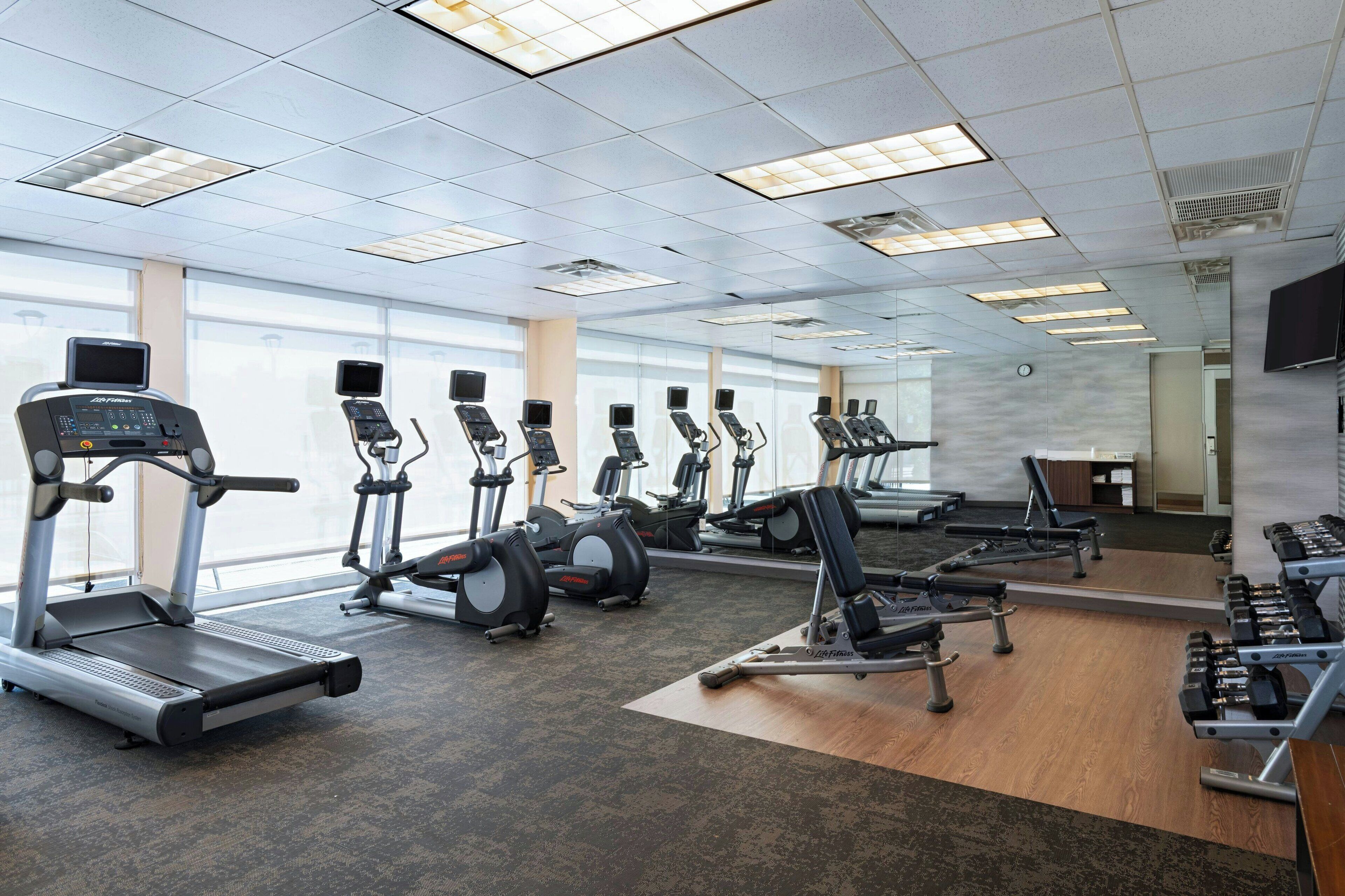 A gym with treadmills, stationary bikes, and weight machines.