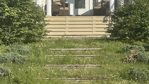 A house with a front porch, columns, and a small seating area.