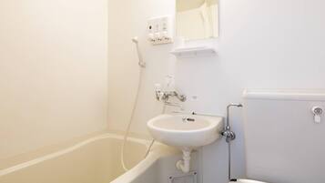A bathroom with a bathtub, a sink, and a toilet.
