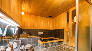 A sauna room with wooden walls, a tiled floor, and a wooden bench. - Lodge Scole (Yamagata)