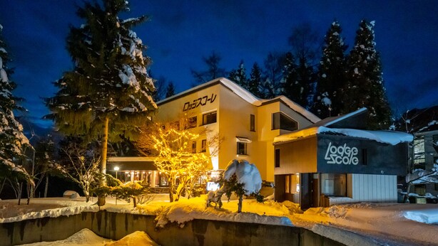 A two-story building with a sign that reads "Lodge Scole." - Lodge Scole (Yamagata)