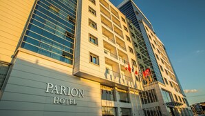 A modern hotel building with a sign reading "PARION HOTEL".