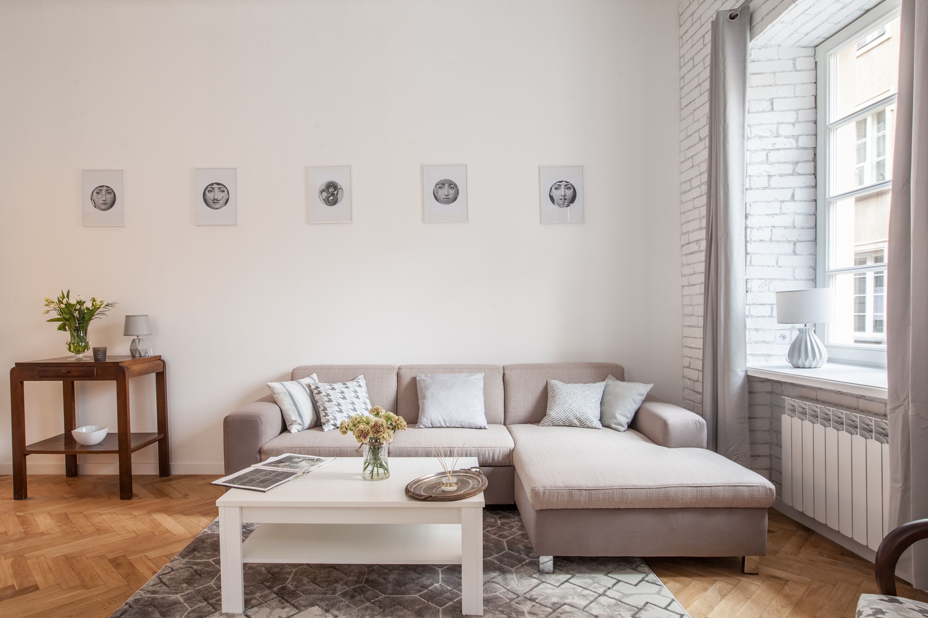 A modern living room with a sofa, a coffee table, and artwork on the wall.