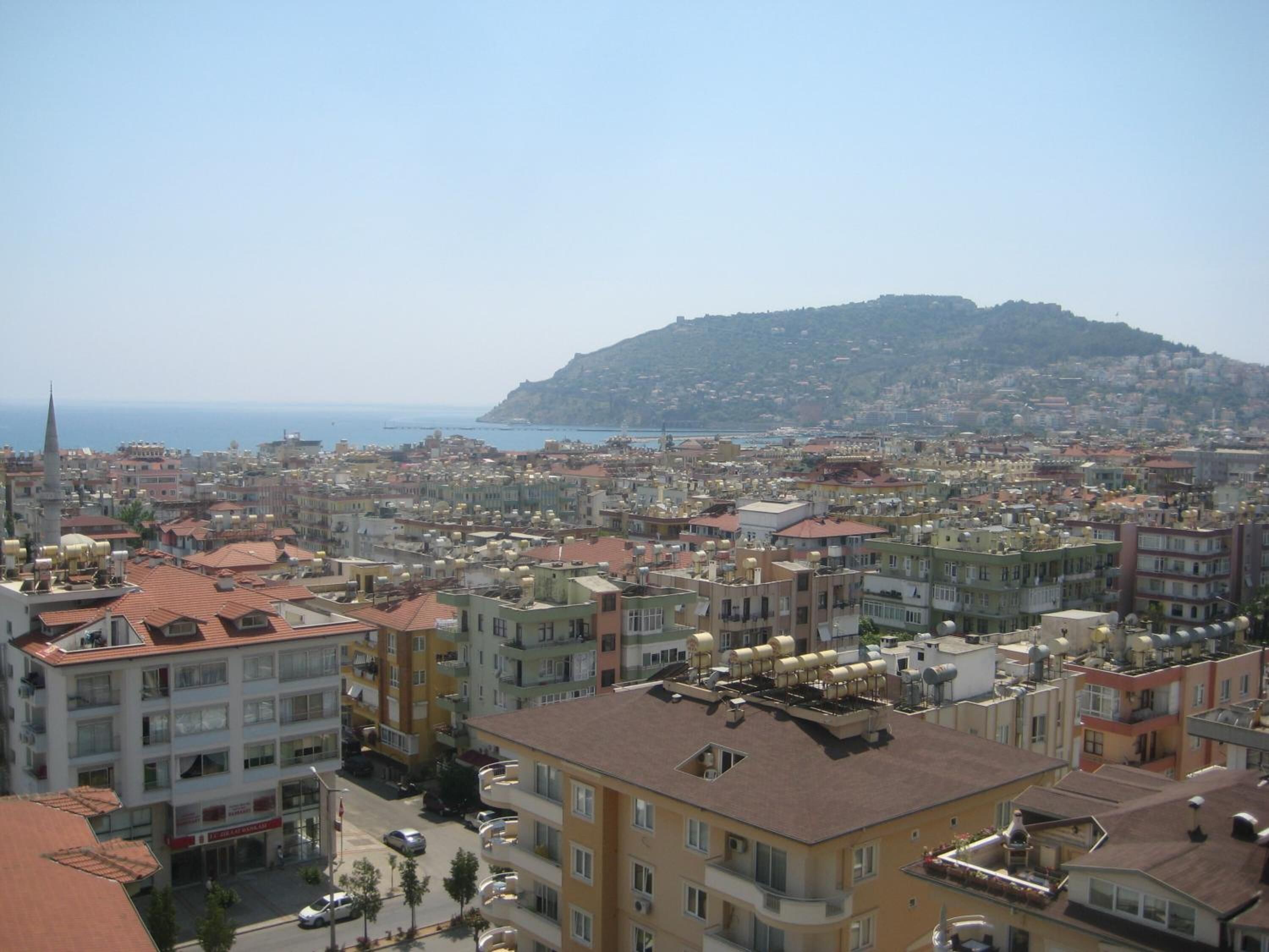 A densely packed urban area with a prominent hill in the background.