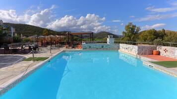 Seasonal outdoor pool, open 10:00 AM to 8:00 PM, pool umbrellas