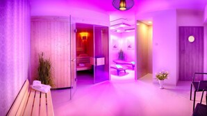 A spa room with a wooden bench, a small plant, and a massage table.