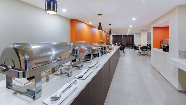 A buffet setup with multiple self-service stations, including grills and serving utensils. - Comfort Inn San Luis Potosi (San Luis Potosi)