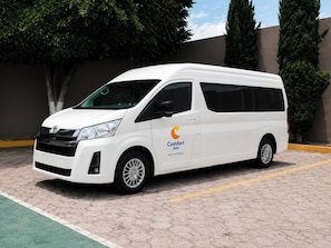 A white van parked in a parking lot with a logo on the side. - Comfort Inn San Luis Potosi (San Luis Potosi)