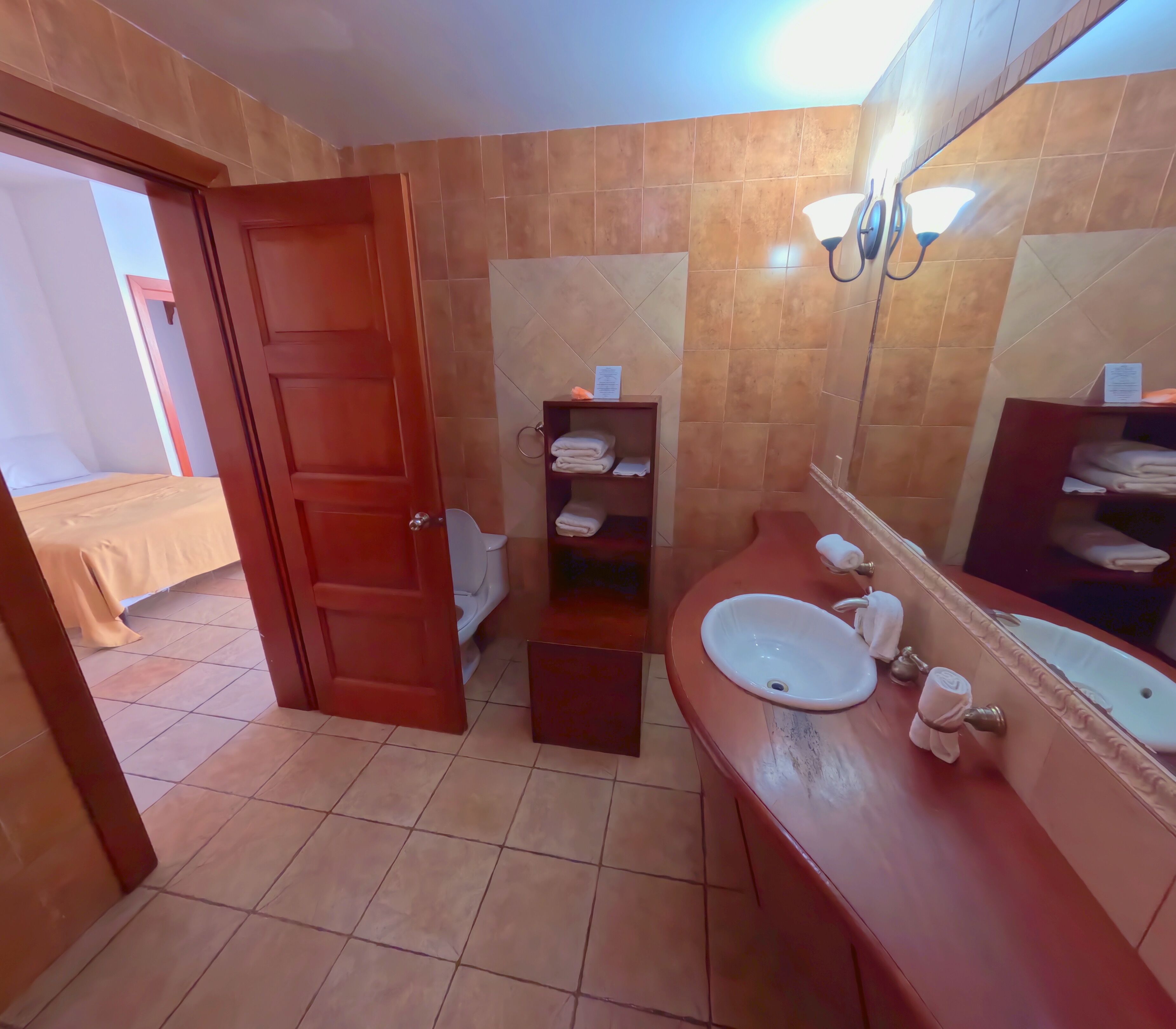 A bathroom with a sink, mirror, and towel rack.