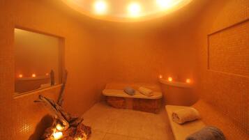 Relax in this cozy space with a bench, mirror, and candles.