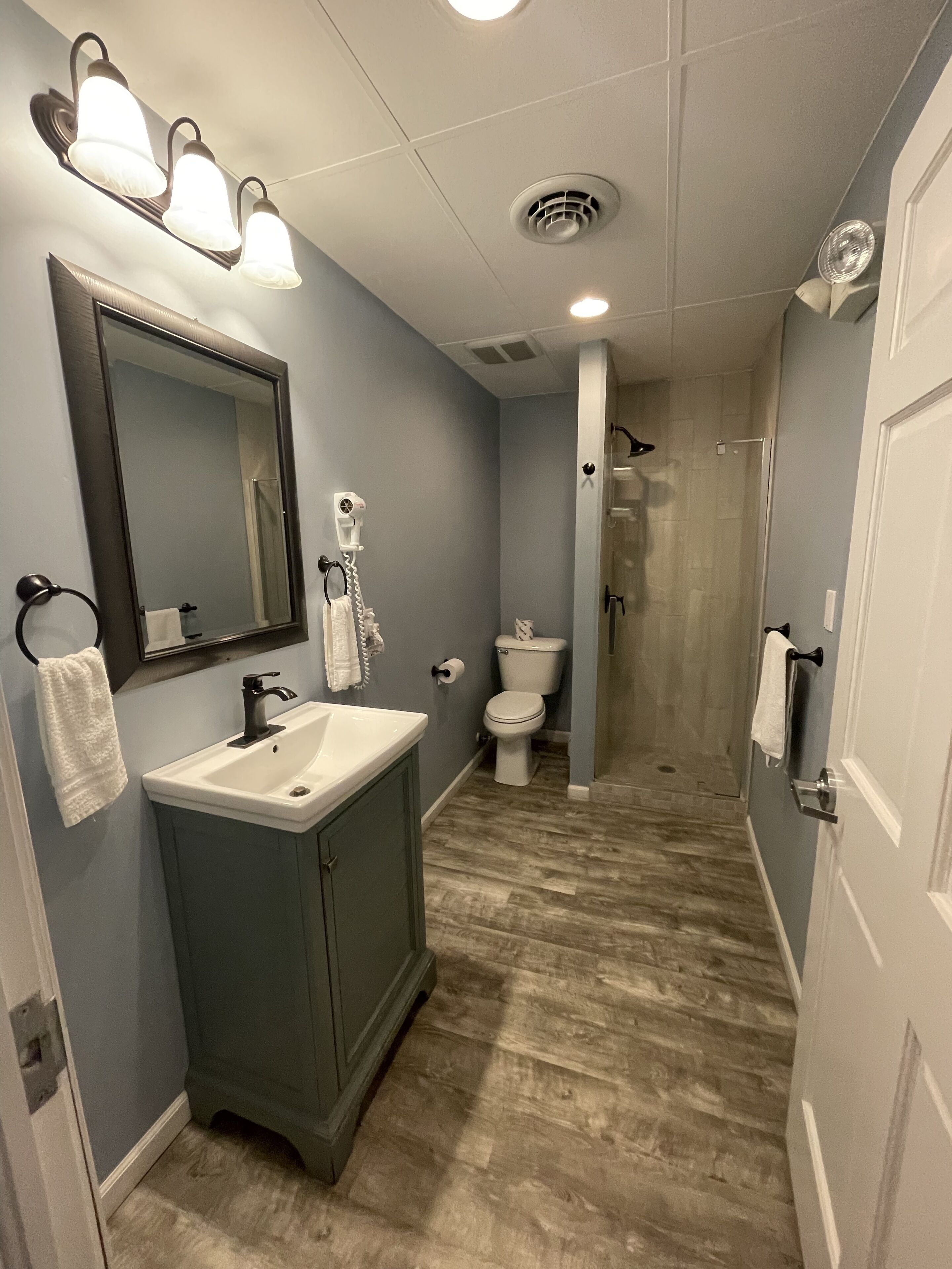 A bathroom with a sink, mirror, and toilet.