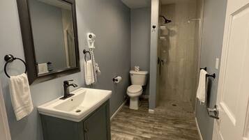 A bathroom with a sink, mirror, and toilet.