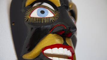 Un gros plan d’un masque dont les yeux et les dents sont particulièrement marqués.