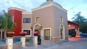 A multi-story building with a dome and arched windows, featuring a gated entrance and potted plants. - Hotel Fiesta Navojoa (Navojoa)