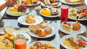 A breakfast buffet with various dishes and drinks.