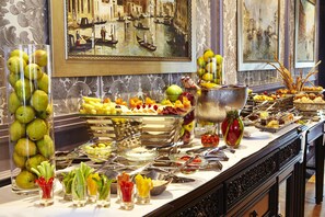 A buffet with various fruits, vegetables, and beverages. - Kempinski Palace Cairo (New Cairo)