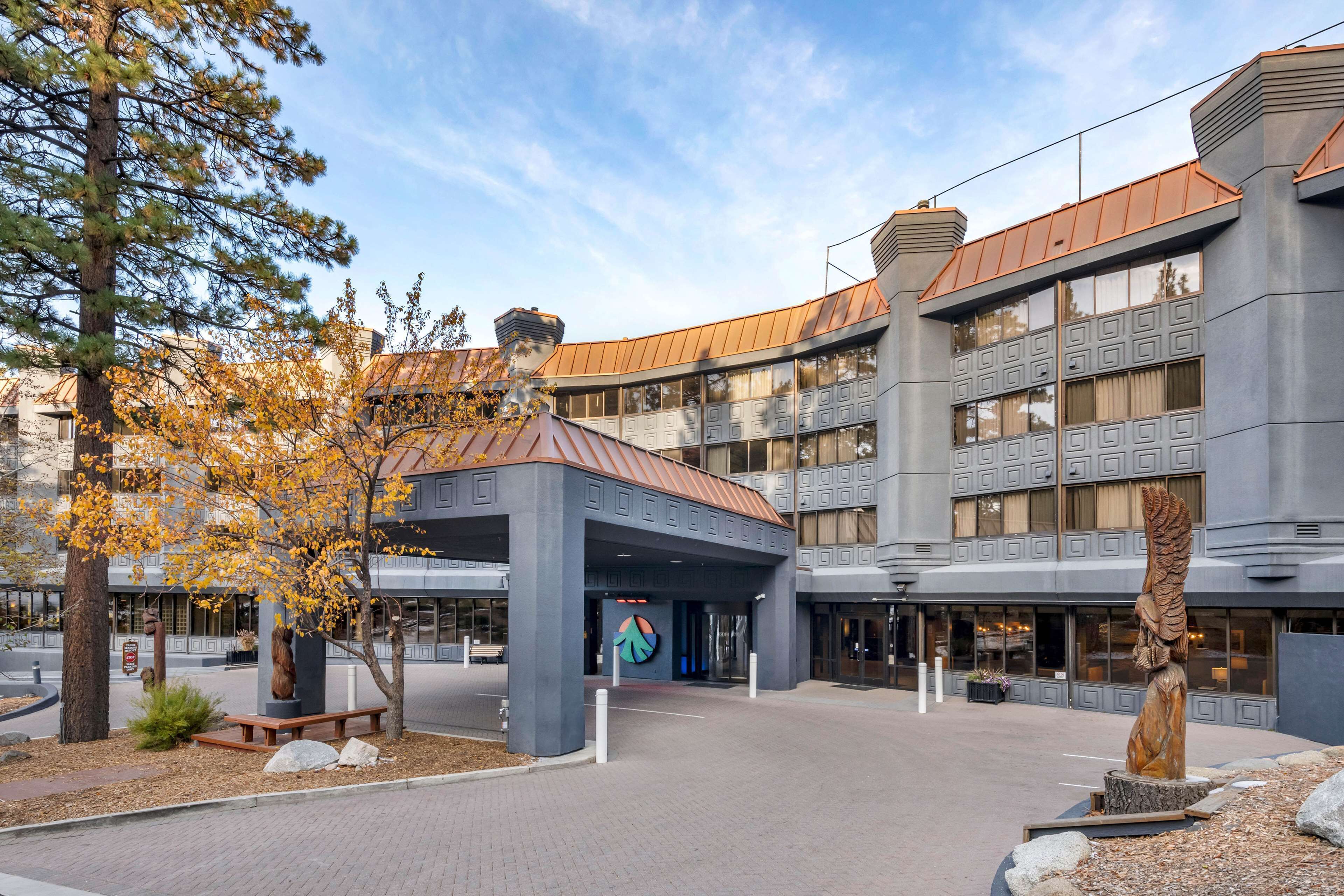 A modern building with a curved roof, large windows, and a central entrance.