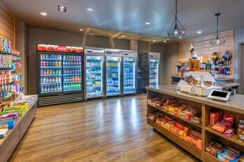 A modern bar area with a wooden counter, multiple beverage dispensers, and a large flat-screen TV mounted on the wall. at Hilton Vacation Club Tahoe Seasons Lake Tahoe