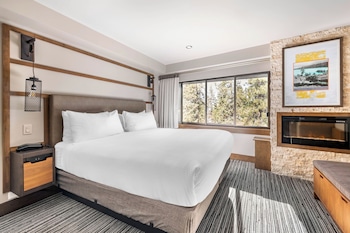 A cozy lounge area with a fireplace, comfortable seating, and a grand piano. at Hilton Vacation Club Tahoe Seasons Lake Tahoe