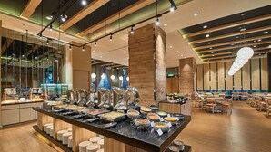 A buffet setup with various food stations and a seating area with tables and chairs. - The Fuli Resort Chihpen (Taitung)