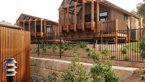 A modern building with a wooden facade and multiple balconies. - Reflections Bonny Hills - Holiday Park (Bonny Hills)