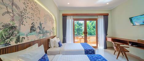 A hotel room with two beds, a desk, a chair, a television, and a view of the outdoors.