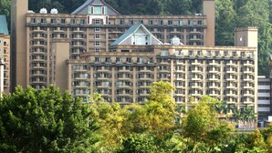 A multi-story hotel with numerous balconies and a central atrium. - Hoya Hot Springs Hotel (Taimali)