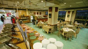 A buffet setup with multiple serving stations and tables. - Hoya Hot Springs Hotel (Taimali)
