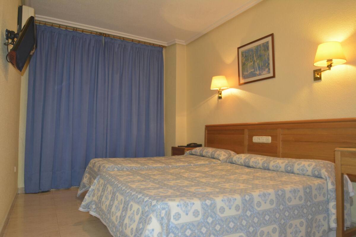 Desk, blackout curtains, iron/ironing board (on request)