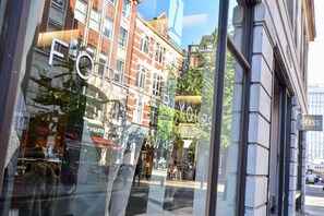 A view of a building with a sign reading "FOREVER YOURS" and another sign "REISS".