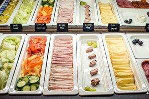 A buffet with various food options including salads, vegetables, ham, pâté, cheese, and meat. - LH Hotel Gold (Cesky Krumlov)