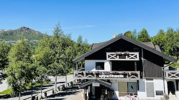 Traditional two-story building with a charming balcony and bike-friendly access.