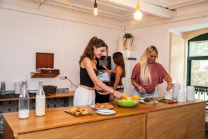 A kitchen area with a wooden countertop, a bottle of milk, and a bowl of lemons.