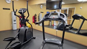 A gym with treadmills, an elliptical, and a water dispenser. - SureStay Studio By Best Western El Dorado (El Dorado)