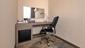 A hotel room with a desk, a chair, a mirror, a lamp, and a television. - Holiday Inn Express Shenyang North Station by IHG (Shenyang)