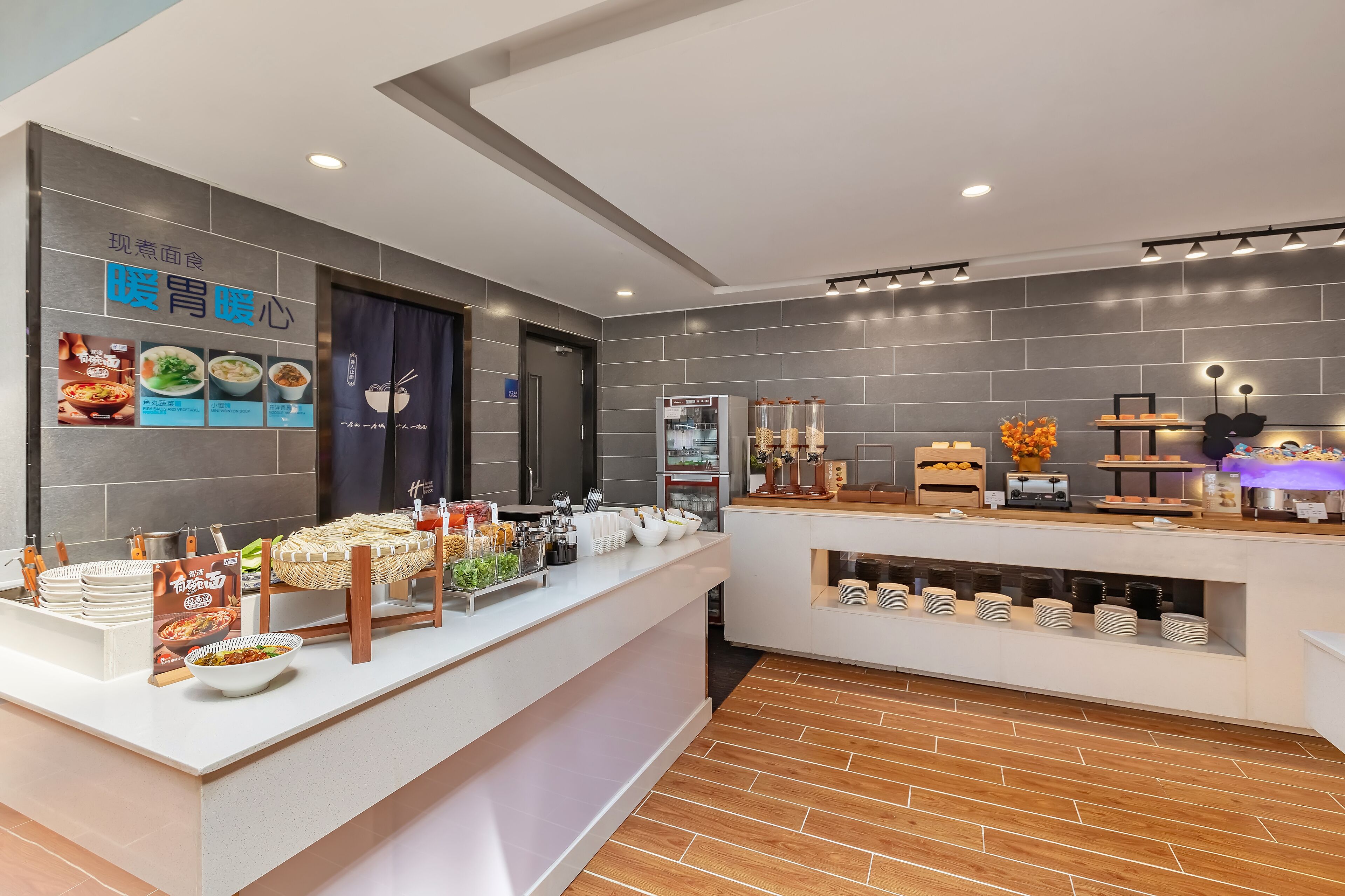A modern buffet setup with various food items and utensils.