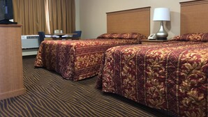 A hotel room with two beds, a desk, a chair, a TV, and a lamp. - Evergreen Lodge (Mount Shasta)