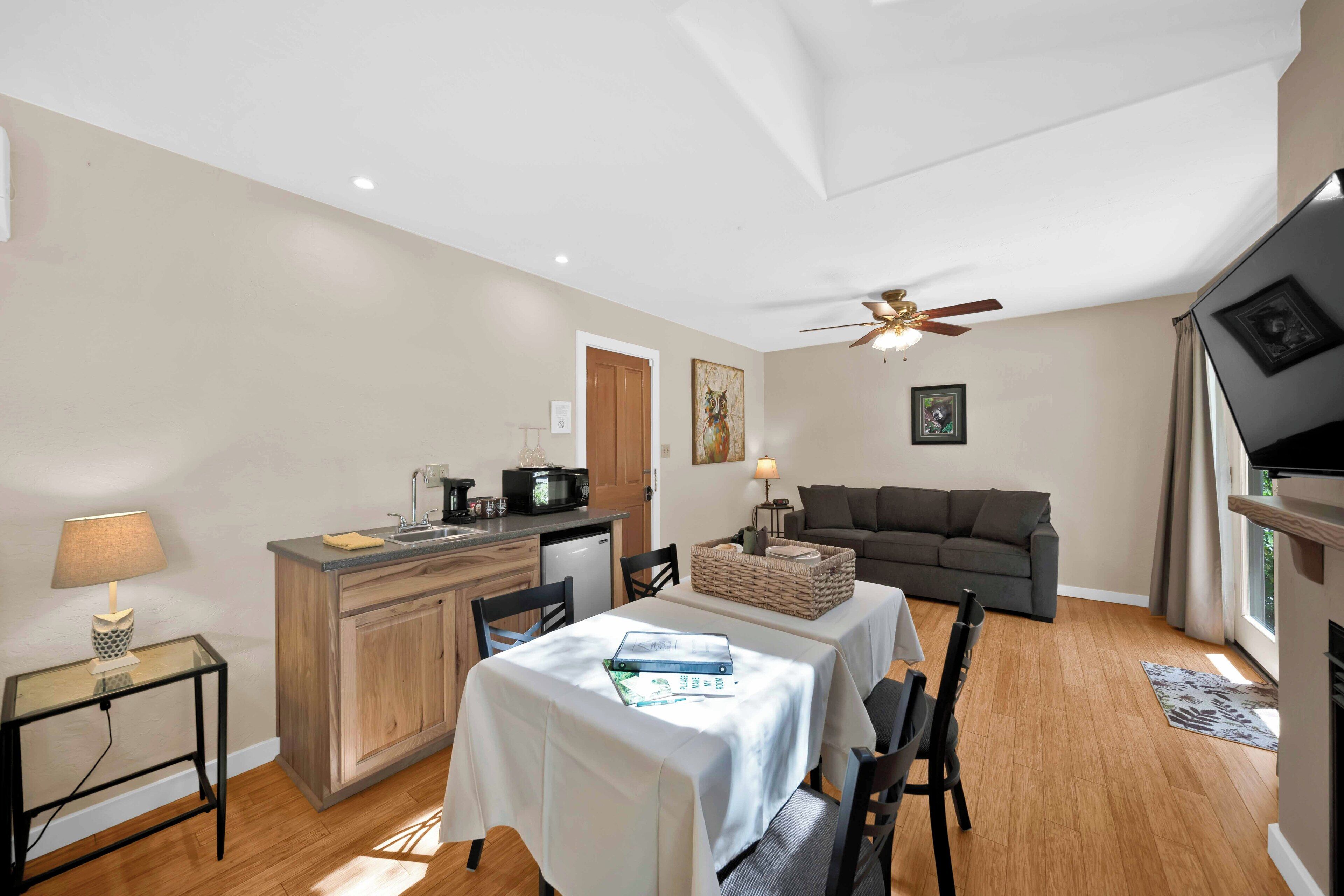 A compact living space with a kitchenette, dining area, and seating area.