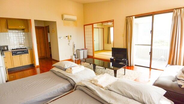 Family Apartment, Multiple Beds, Ocean View | Living area | LCD TV - Resort Mansion Sea Zone (Onna)