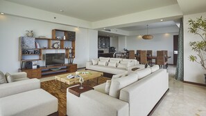 A modern living room with a sofa, coffee table, and entertainment unit. - The Sintesa Jimbaran Bali (Jimbaran)