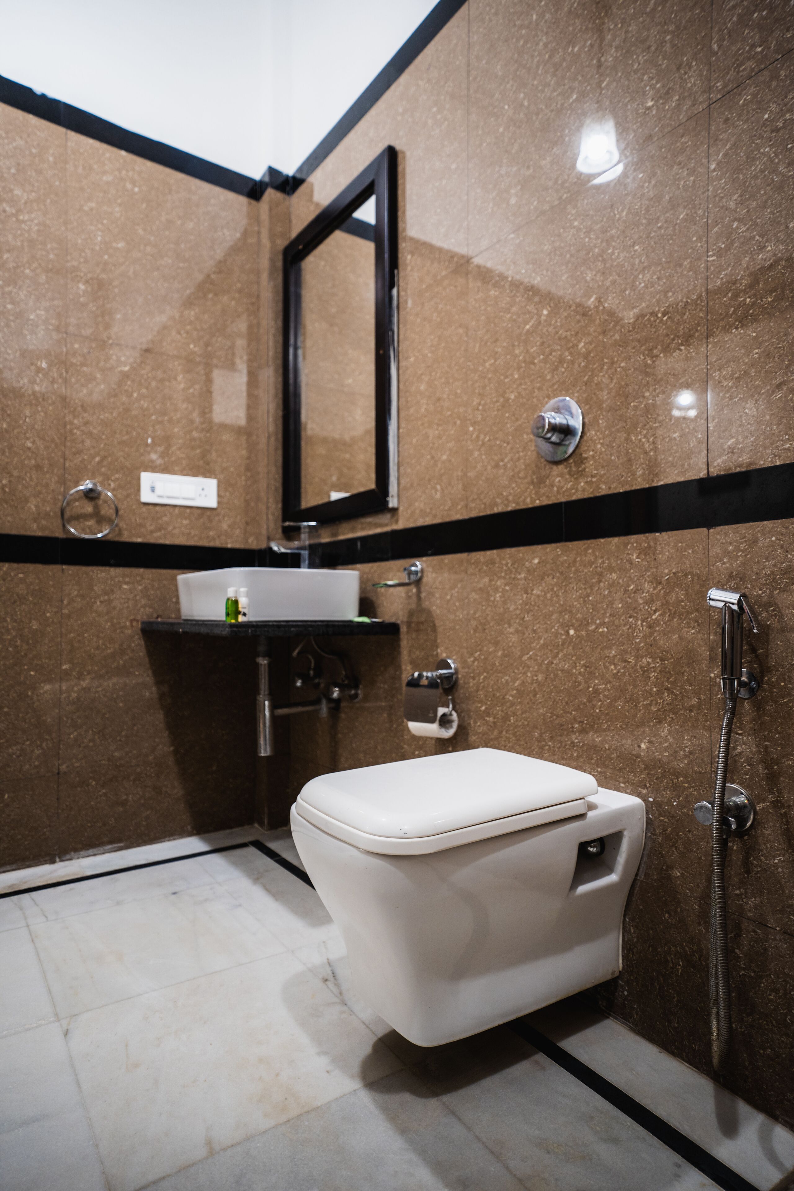 A modern bathroom with a toilet, sink, and shower.