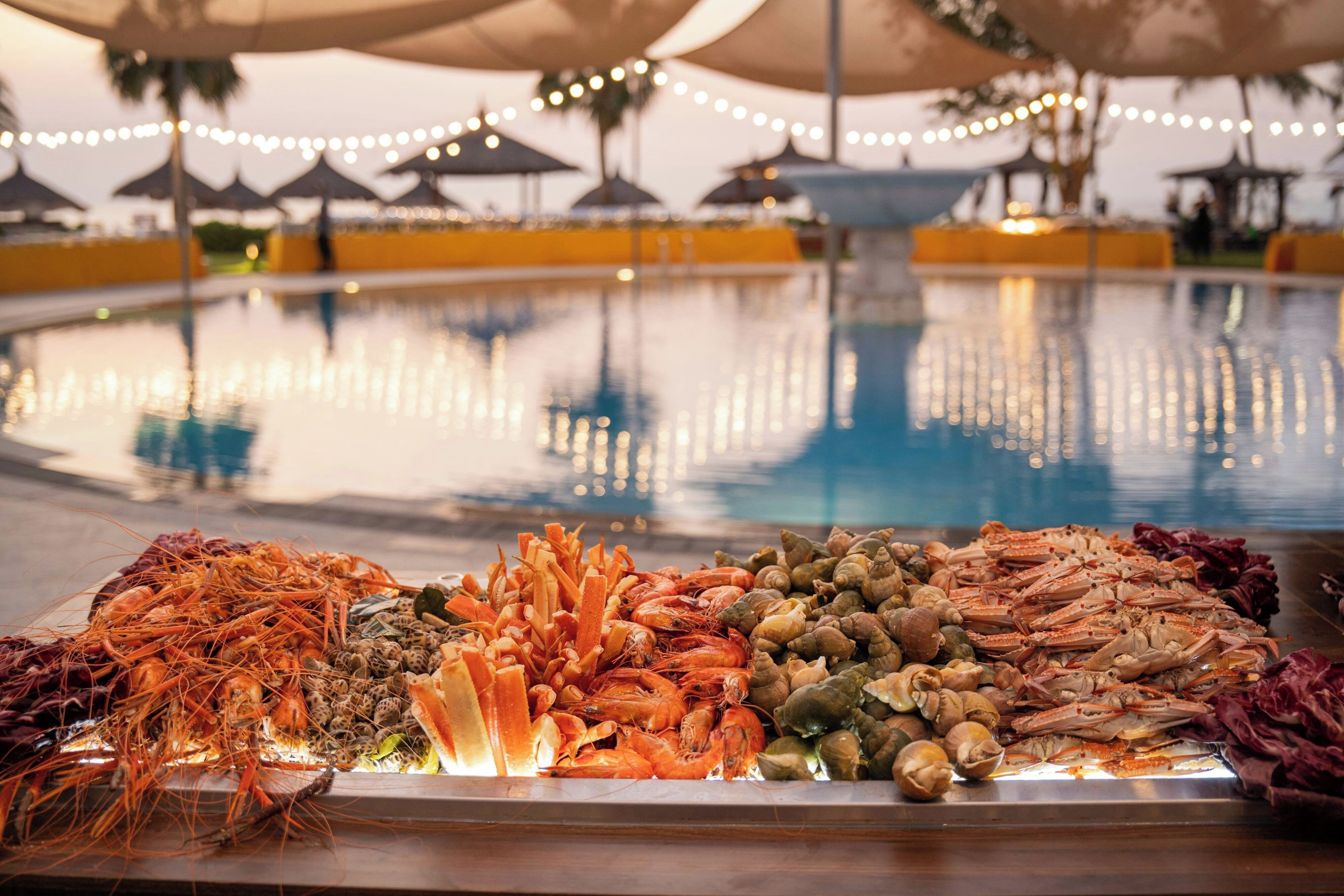 A seafood display with various types of shellfish and prawns.