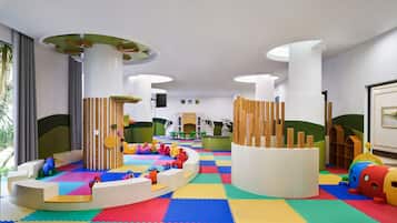 Children can play and explore on a colorful play mat and interactive play structure.