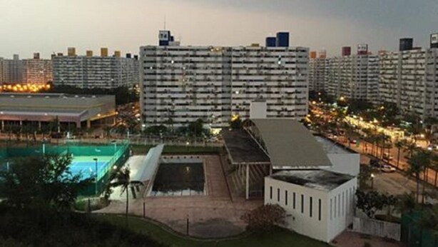 A high-rise residential building with multiple balconies, a swimming pool, and a covered outdoor area. - Don Mueang-Challenger Impact Muangthong Thani (Pak Kret)
