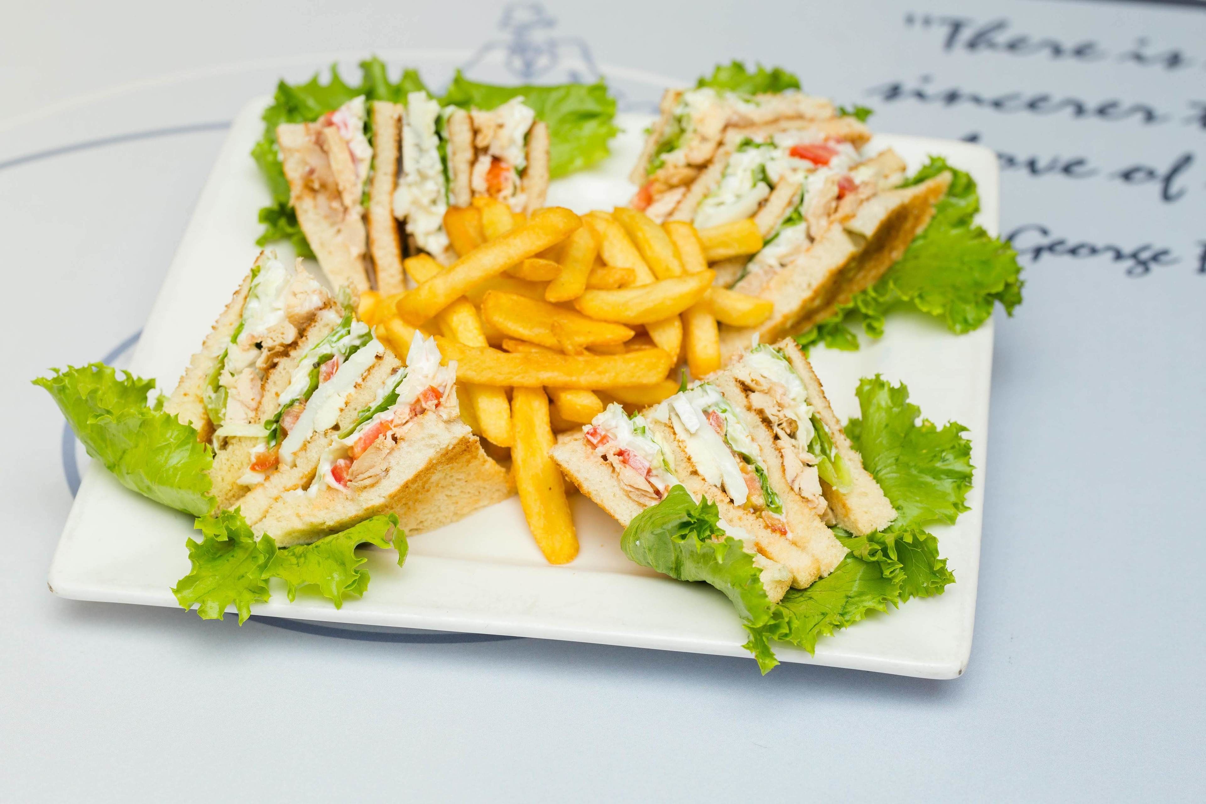 A plate of sandwiches and French fries.