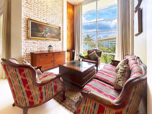 A living room with a brick wall, a wooden cabinet, a sofa, and a coffee table.