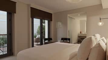 A bedroom with a large bed, a chair, a small table, a mirror, and a balcony with outdoor furniture.