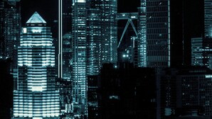A nighttime cityscape with prominent skyscrapers, including two tall, illuminated towers. - Canary Hotel (Kuala Lumpur)