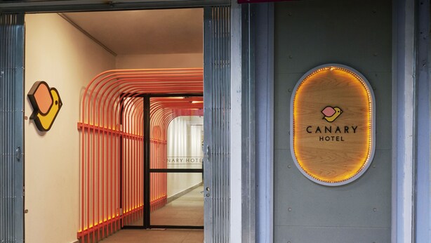 The entrance to the Canary Hotel with a modern design, featuring a glass door and a sign with the hotel's name. - Canary Hotel (Kuala Lumpur)
